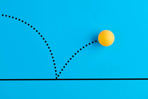 Yellow ball bouncing with dotted trajectory on blue background.