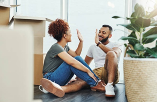 Two people high-five each other.